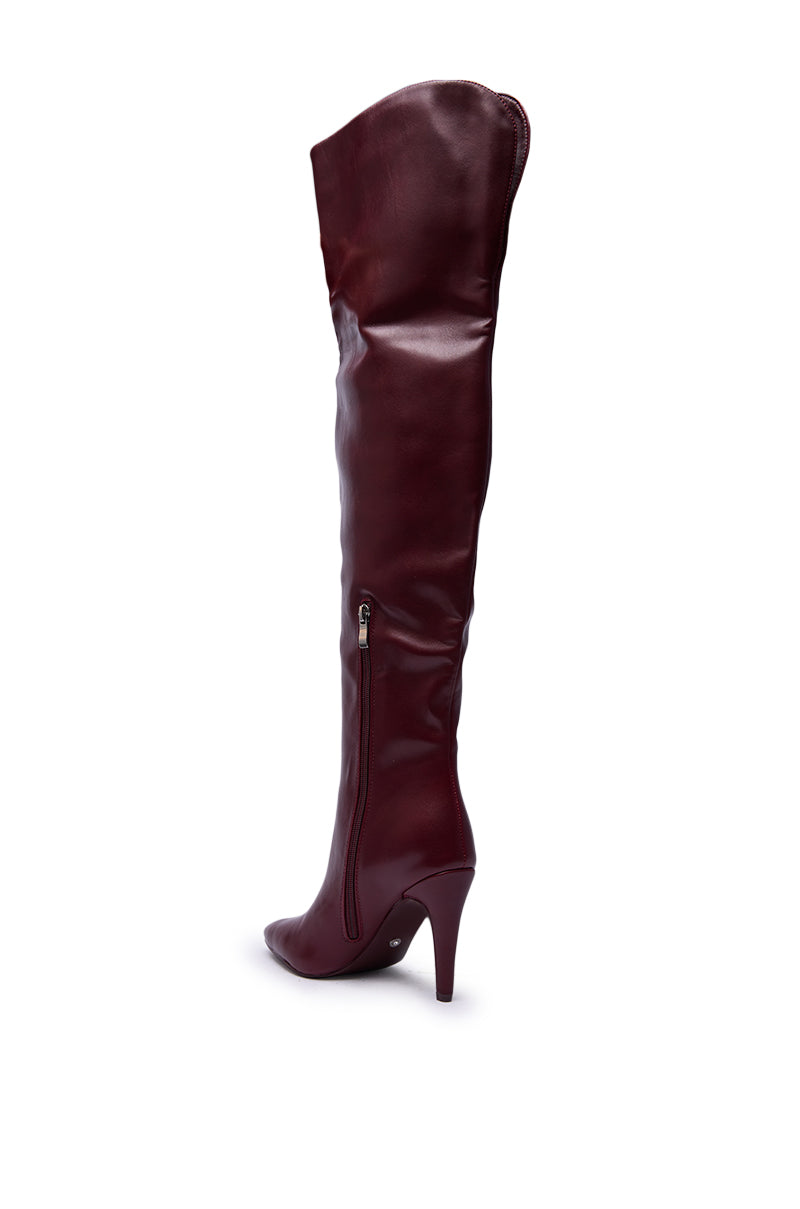 The AZALEA WANG BEAUCOUP BURGUNDY OVER THE KNEE BOOT is a sleek faux leather stiletto with a side zipper, shown in burgundy against a white background.