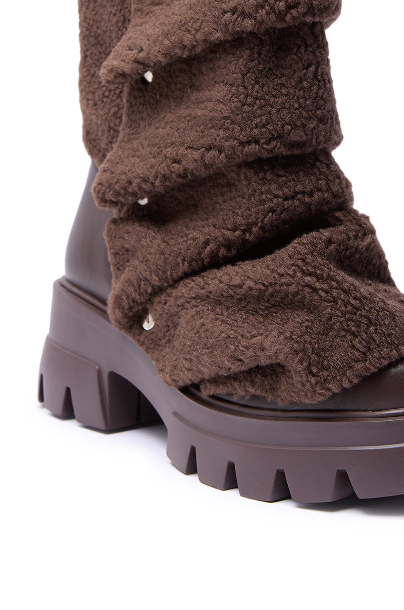 Close-up of the AZALEA WANG BEHATI BROWN SHERPA BOOTIE WITH SNAP DETAIL, showcasing a plush fleece-like upper, chunky ridged sole, and snap accent—combining cozy faux sherpa warmth with a stylish, rugged silhouette.
