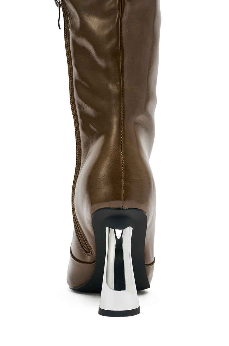 Close-up rear view of the AZALEA WANG BEHRAM Olive Knee High Boot, featuring smooth faux leather, a shiny chunky silver curved heel, and side zipper detail. 6