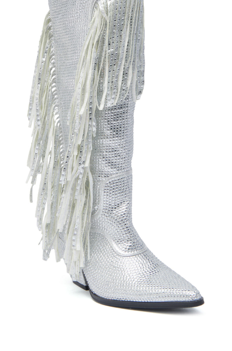 The AZALEA WANG BENNETTO SILVER RHINESTONE WESTERN BOOT features a sparkling silver rhinestone texture, pointed toe, chunky heel, and long white fringe detailing along the side.