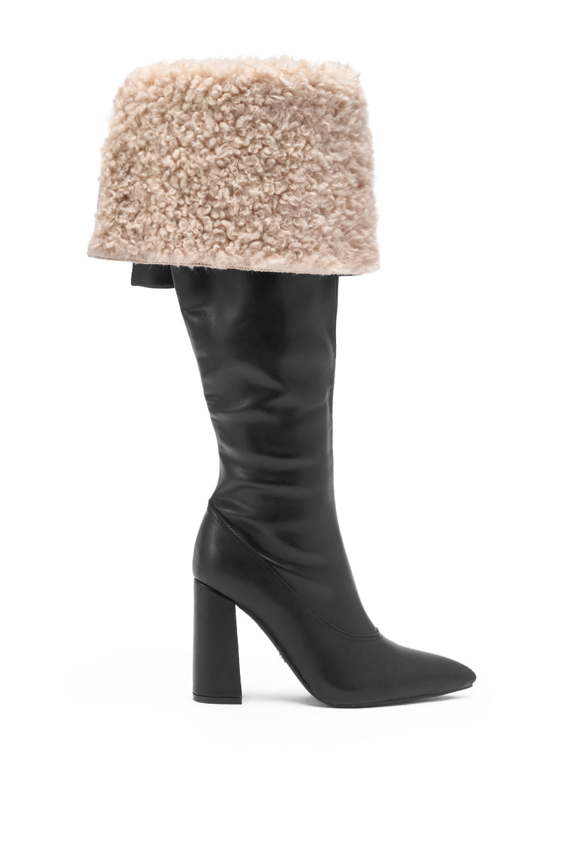 The AZALEA WANG BENOUL BLACK SHERPA LINED CHUNKY BOOT features a black faux leather finish, a tall beige shearling cuff, chunky heel, and knee-high silhouette, making it stand out against a white background.