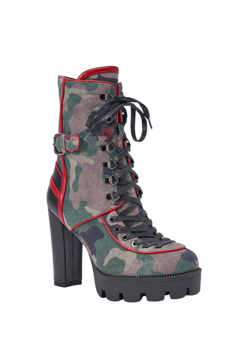 The AZALEA WANG BENSON CAMO BLOCK SPORTY BOOTIE is a high-heeled lace-up platform with a chunky sole, green camo pattern, red trim, black laces, and a decorative side buckle—ideal for bold streetwear style. 4