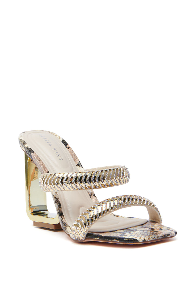 The AZALEA WANG BESSIE BROWN MULTI SNAKE WEDGE SANDAL flaunts a faux leather snake print with two rhinestone-encrusted straps across the foot and a chic gold-toned block heel, merging elegance and modern style. 4