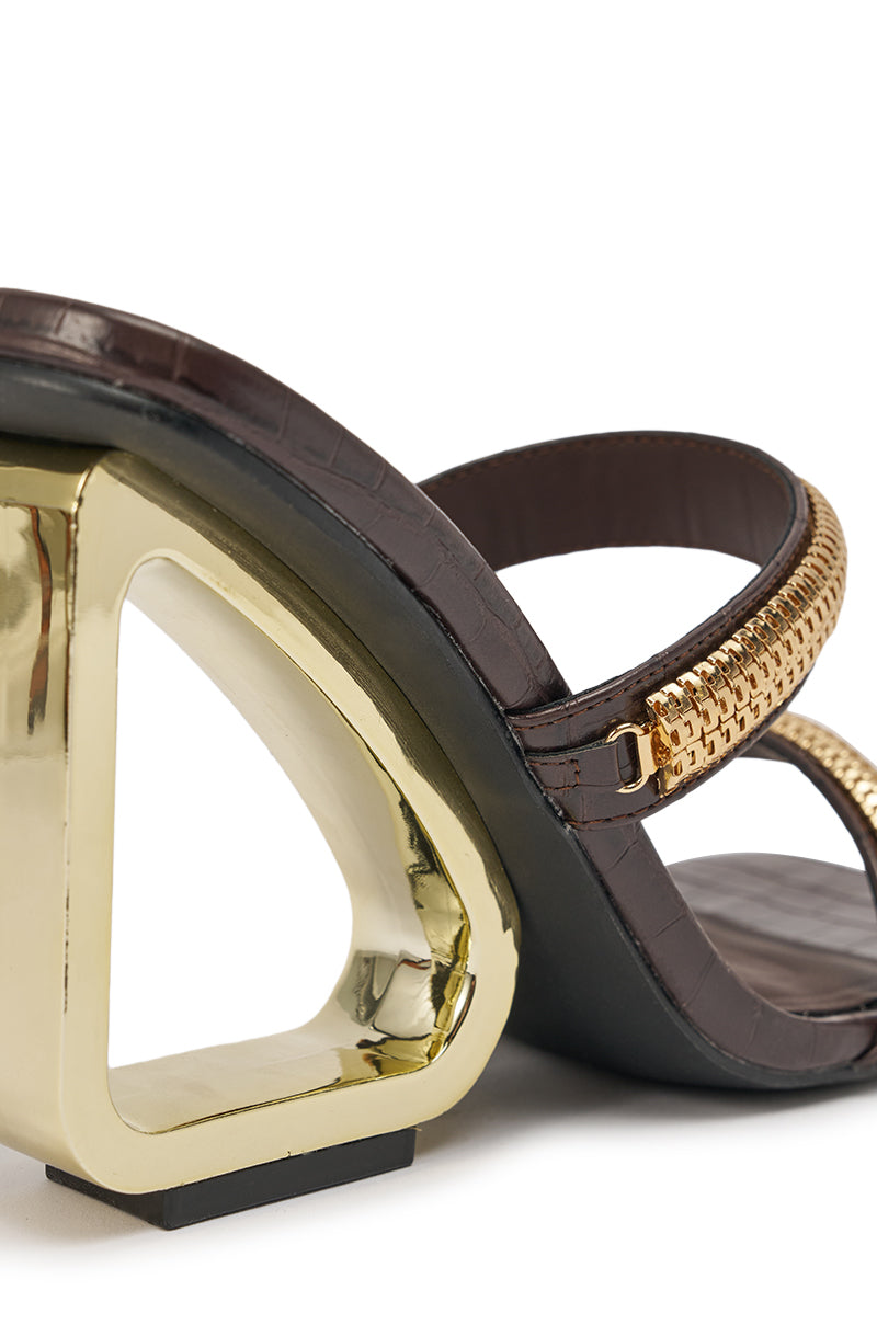 Close-up of the AZALEA WANG BESSIE CHOCOLATE CROC GOLD EMBELLISHED WEDGE SANDAL, featuring dark brown croc-embossed faux leather straps, a geometric gold wedge heel, and a gold chain detail on the upper strap. 7