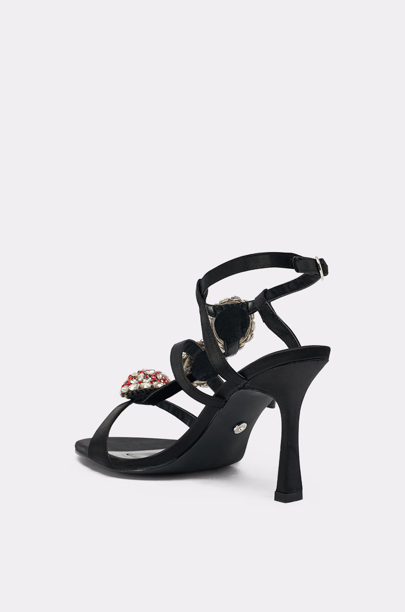 The AZALEA WANG BEST BLACK RHINESTONE EMBELLISHED STILETO SANDAL, with thin straps, buckle ankle closure, and jeweled details on the strap and heel, is shown against a white background.