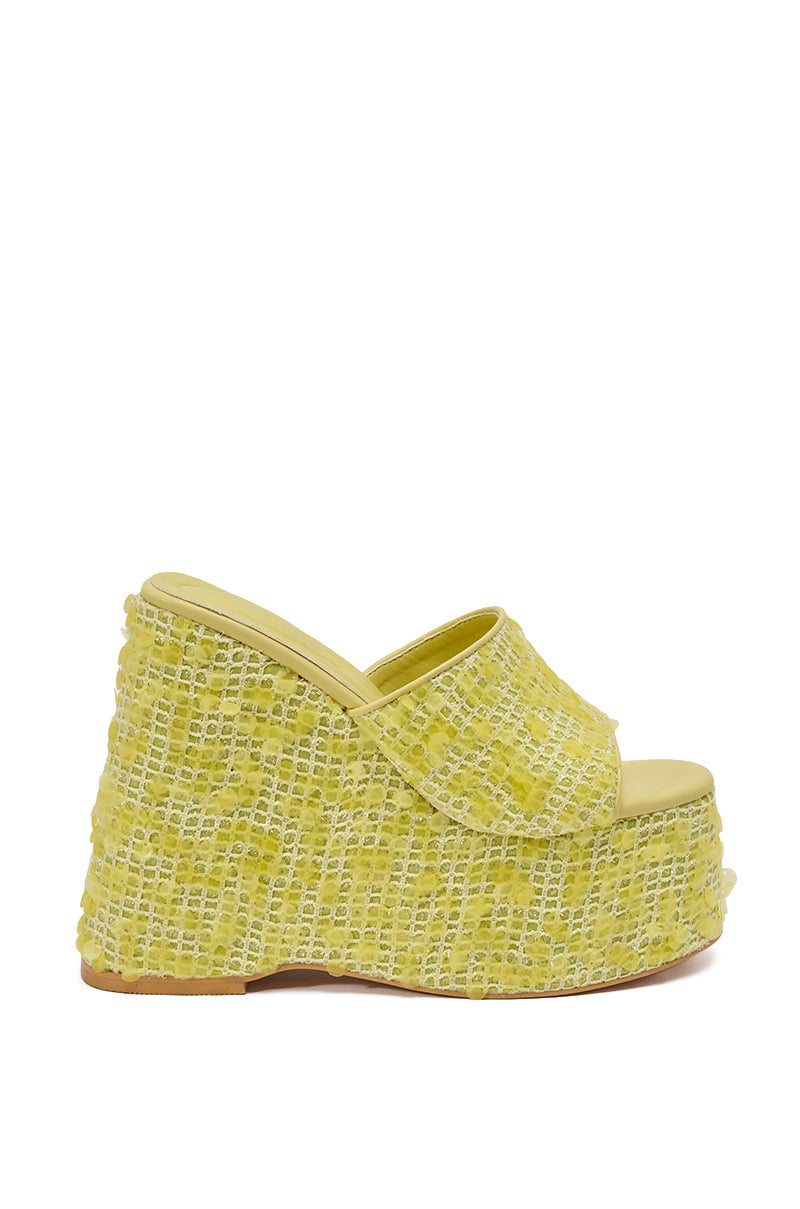 The AZALEA WANG BETSEY YELLOW SEQUIN RAFFIA WEDGE features a side-view platform wedge sandal with an open toe and woven textured raffia upper, adding a bold pop of yellow to any outfit. 4