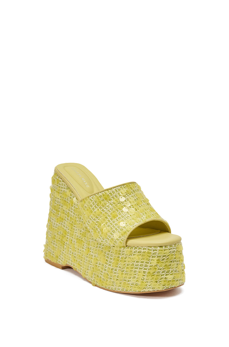 The AZALEA WANG BETSEY YELLOW SEQUIN RAFFIA WEDGE is a yellow woven platform sandal with open toe and back, featuring two gold studs, a thick textured sole, and subtle sequin details for extra sparkle. 5
