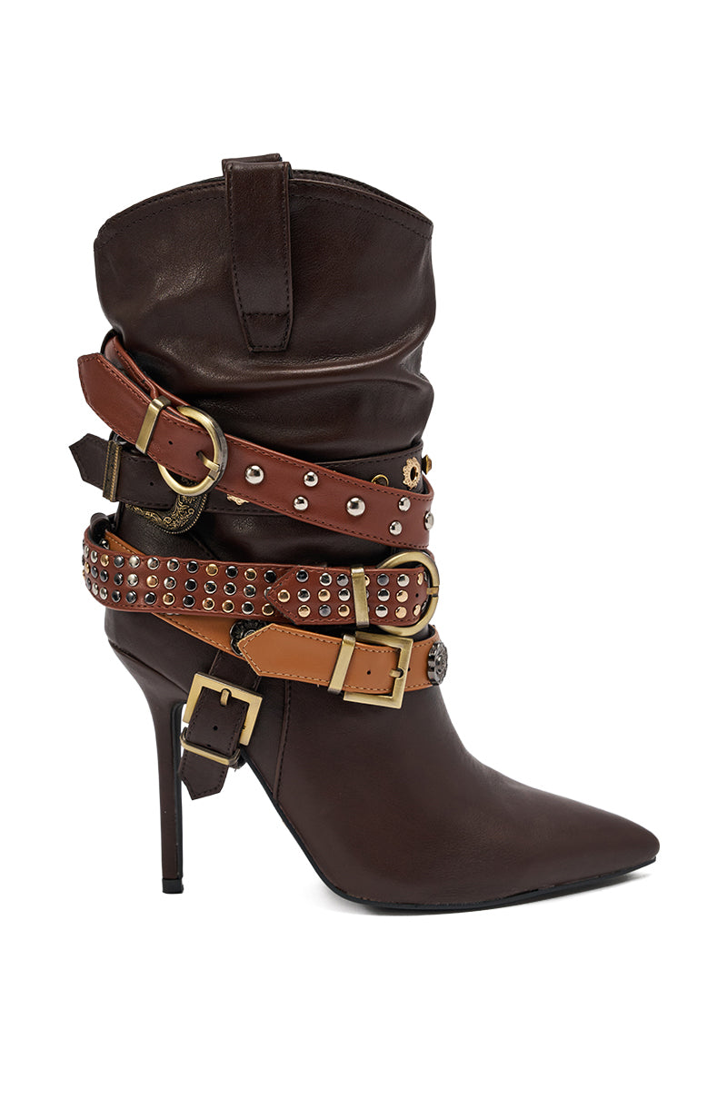 The AZALEA WANG BROWN STILETTO BOOTIE is a dark brown, pointed-toe faux leather bootie with high heels, decorative multi-shade brown straps, metal studs, and gold hardware accents.
