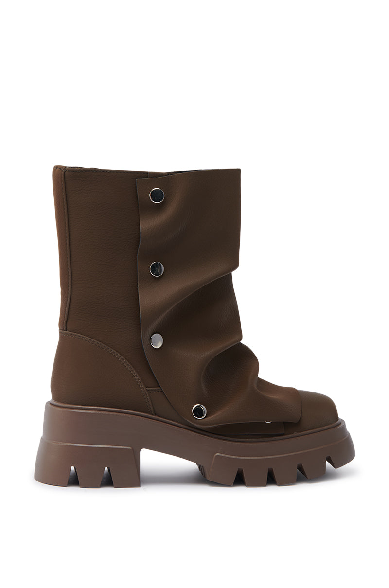The AZALEA WANG BHARTI BROWN FLAT BOOTIE features a brown, mid-calf design with a lug sole, metallic snap buttons, and a slouched faux leather upper—delivering modern edge and visible stitching details. 6