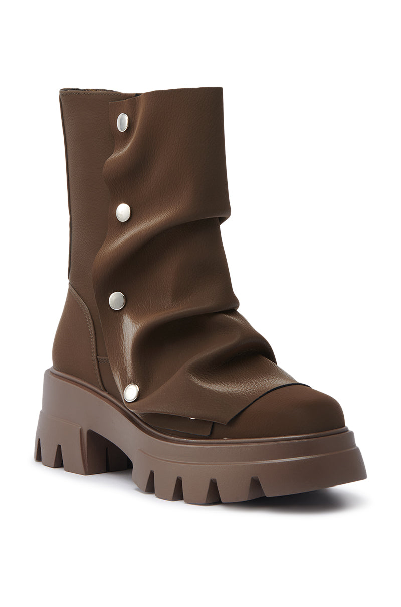 The AZALEA WANG BHARTI BROWN FLAT BOOTIE is a single brown boot featuring a soft faux leather upper, slouchy design, large silver snap buttons on the side, and a ridged lug sole. 7