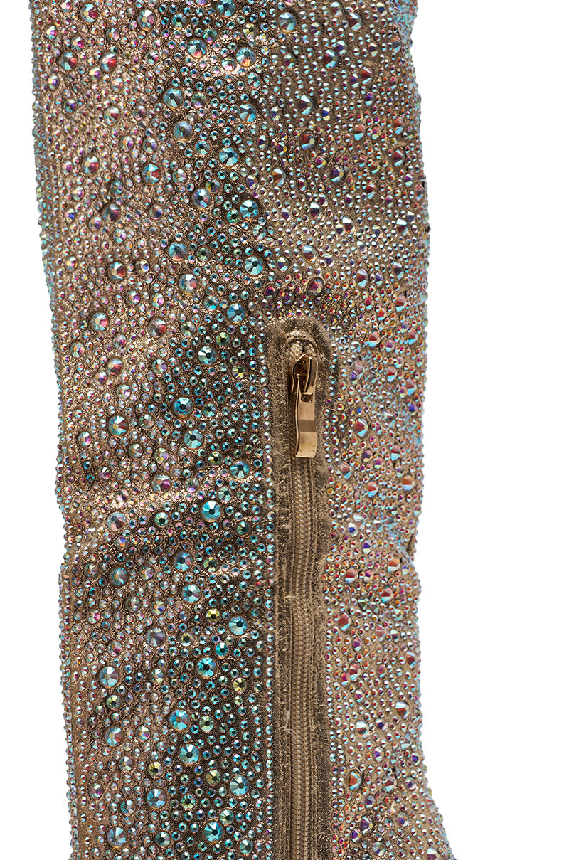 Close-up of the AZALEA WANG BIBBLE GOLD RHINESTONE STILETTO OVER THE KNEE BOOT in brown suede, embellished with iridescent rhinestones and a gold side zipper.