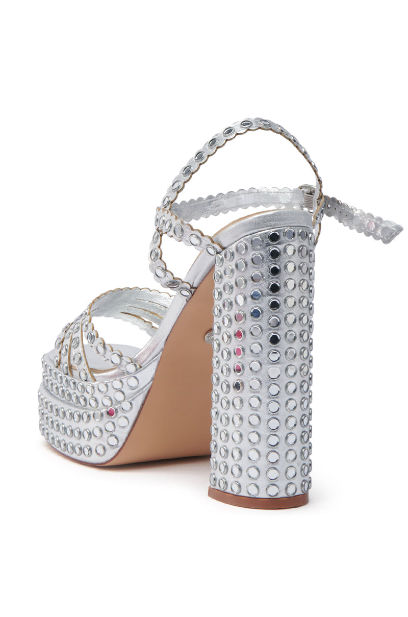 The AZALEA WANG BIRCH Silver Embellished Sandal features an open square toe adorned with shiny studs, a chunky heel, ankle strap, and a beige sole.