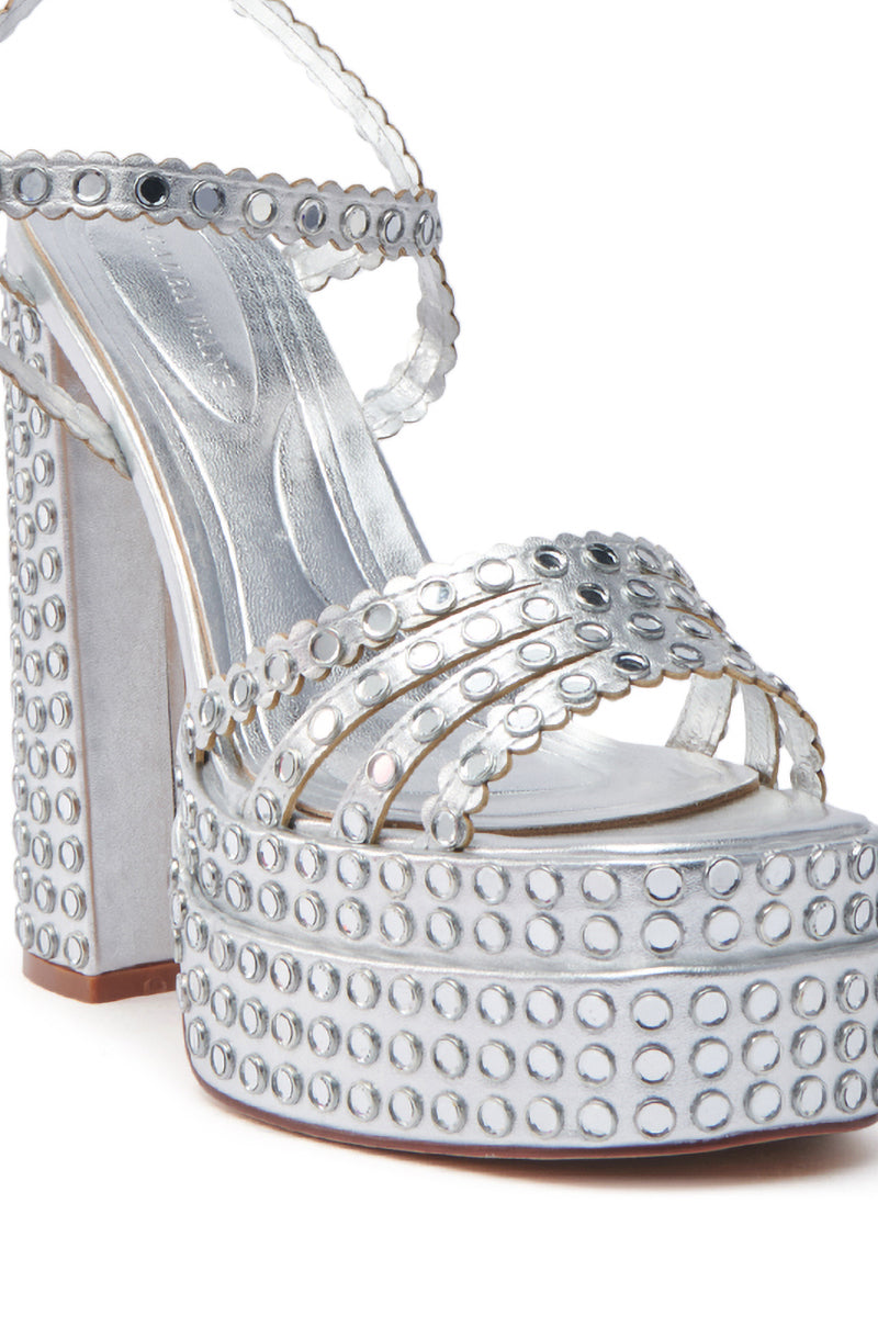 Close-up of the AZALEA WANG BIRCH SILVER EMBELLISHED SANDAL, showcasing an open square toe, chunky platform, and block heel with round silver studs. It features multiple straps and a shimmering metallic finish.