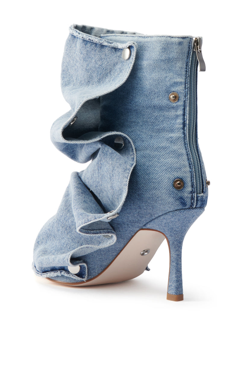 The AZALEA WANG BIRD SONG DENIM OPEN TOE SNAP BOOTIE features a high heel, jean-like design with ruffled folded layers, metallic buttons, back zipper, and a slim tan stiletto heel with a light sole.