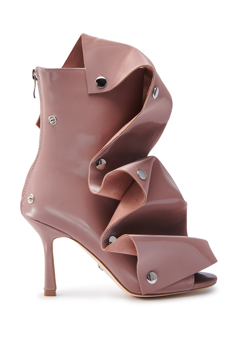 The AZALEA WANG BIRD SONG SNAP OPEN TOE BOOTIE in mauve is a unique high-heeled shoe crafted from faux patent leather with sculptural folds, a glossy finish, and silver button accents, resembling layered, twisted fabric for an intricate and artistic look.