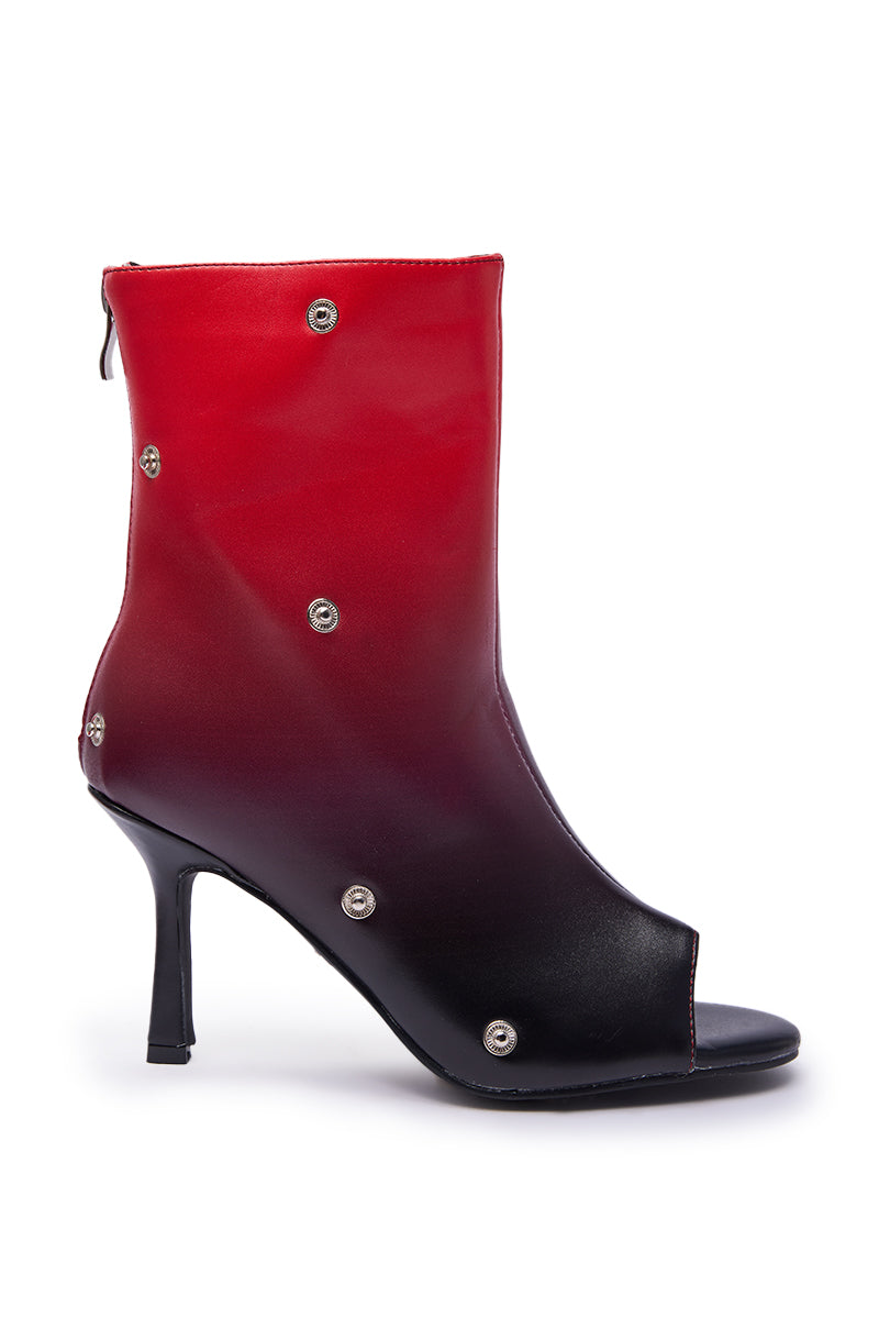 The AZALEA WANG BIRDSONG RED OMBRE SNAP OPEN TOE BOOTIE features a stiletto heel, back zipper, metallic snap accents, faux leather, and a bold red-to-black ombre design on white.