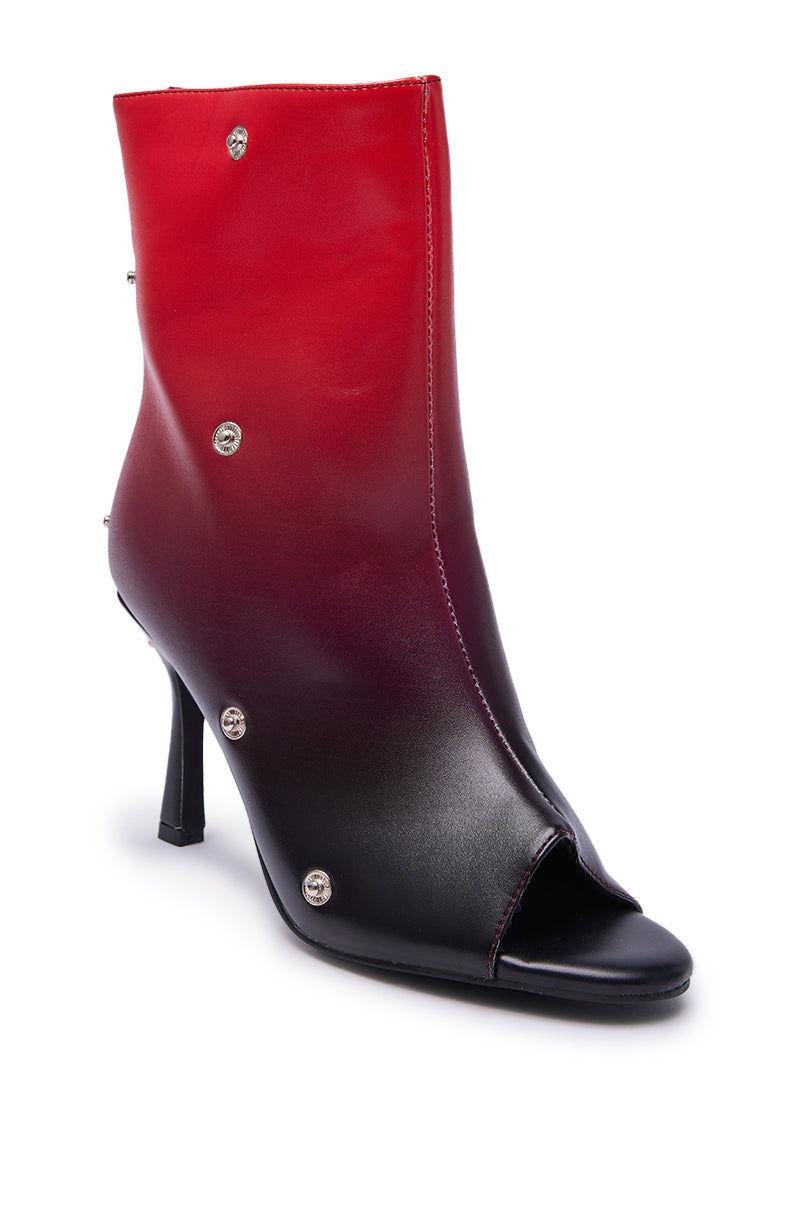 The AZALEA WANG BIRDSONG RED OMBRE SNAP OPEN TOE BOOTIE features a high peep toe, slim stiletto heel, silver button accents on the side, and shiny red ombre faux leather for a bold, eye-catching look.
