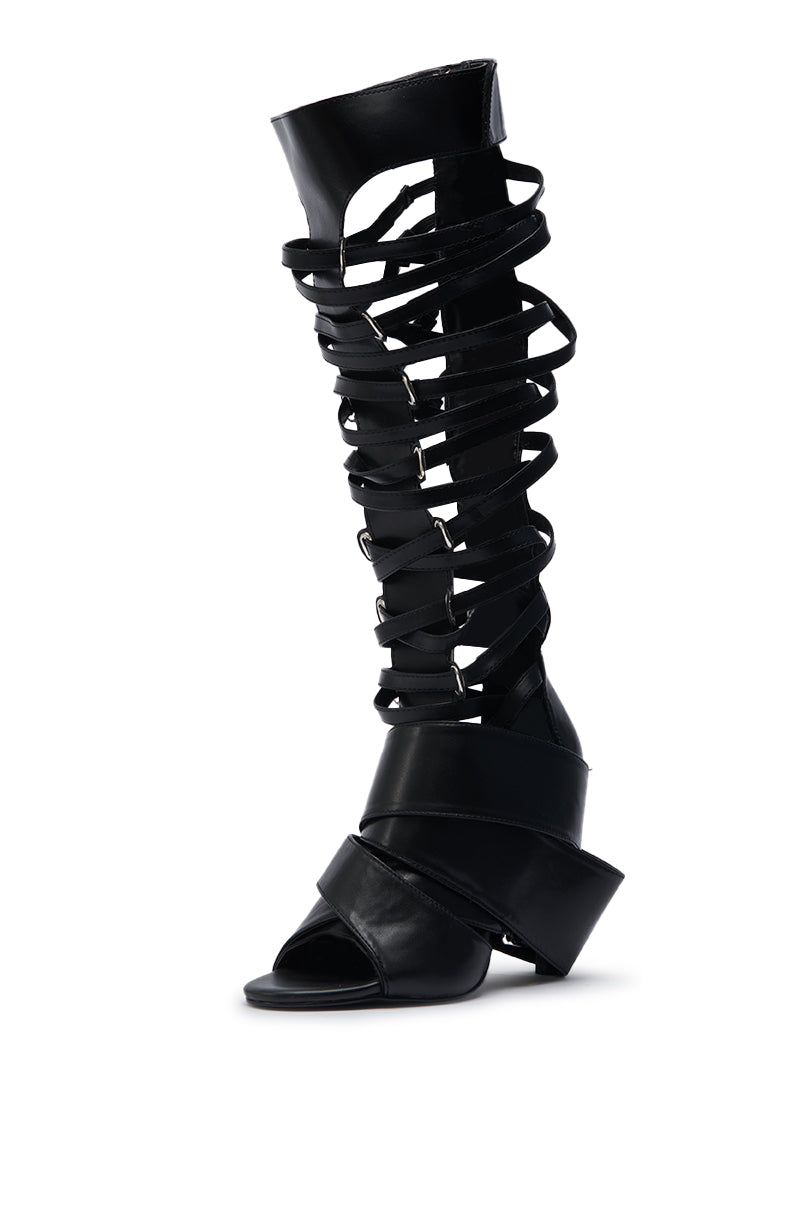 The AZALEA WANG BLACKBIRD BLACK PU STILETTO GLADIATOR SANDAL features a stiletto heel, open toe, and multiple overlapping straps up to the knee for a bold, stylish look.