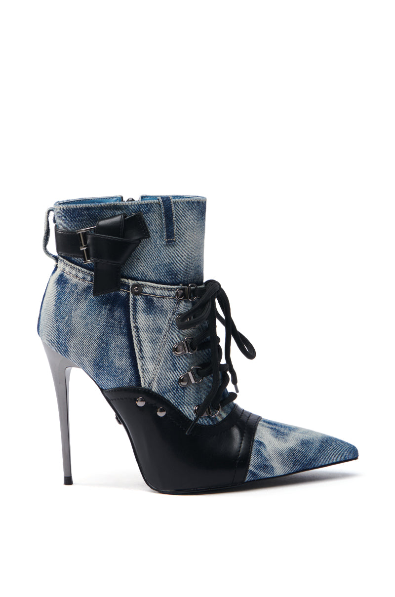 Introducing the AZALEA WANG BLANCHE DENIM STILETTO BOOTIE, a stylish high-heeled boot featuring an ankle-high shaft. It has a pointed toe, lace-up front with metallic eyelets, denim and leather elements, sleek black stiletto heel, black bow embellishment, and side zipper.