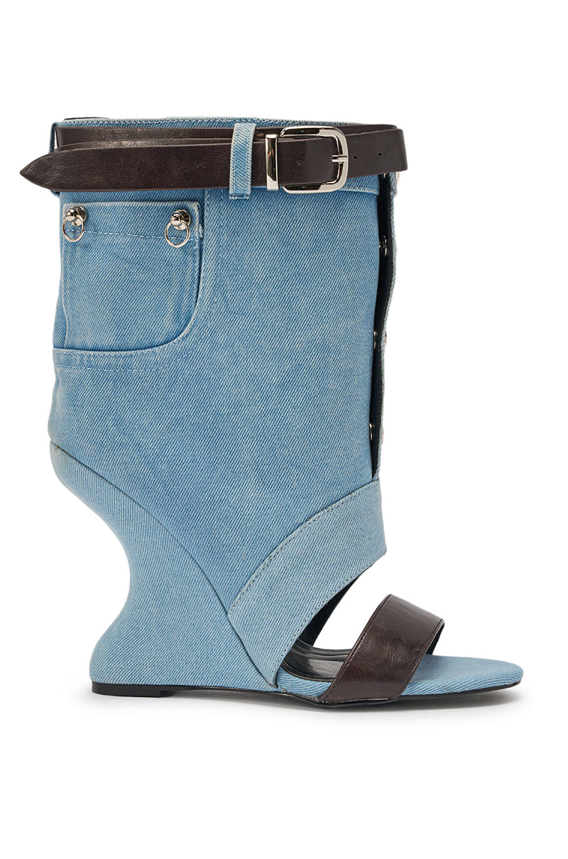 The AKIRA GOLD BLEILIC DENIM WEDGE OPEN TOE BOOTIE features a blue jean-inspired design with a pocket, silver buttons, black ankle belt, and toe strap—a bold streetwear statement with a sculptural high wedge heel. 3