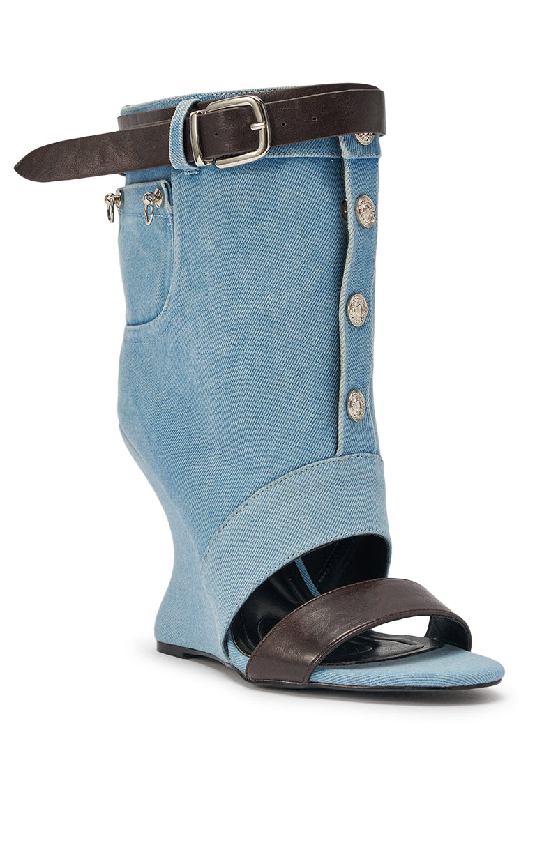 The AKIRA GOLD BLEILIC DENIM WEDGE OPEN TOE BOOTIE features light blue denim, silver buttons, a slanted wedge heel, open toe, and a dark brown leather ankle strap with buckle—perfect for statement streetwear. 4