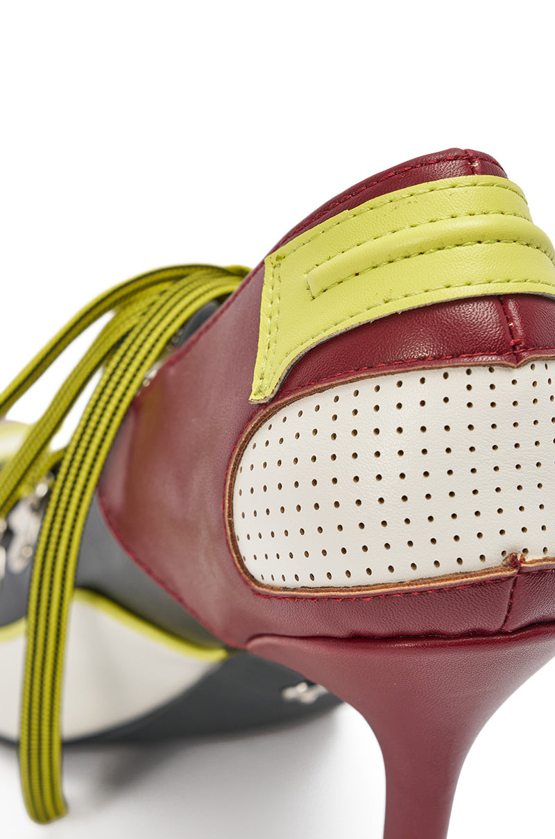 Close-up of the AZALEA WANG BLITZ MULTI COLOR LACE UP STILETTO PUMP featuring red, yellow-green, and white colorblock panels, perforated details, yellow-green laces, and a slender stiletto heel. 5