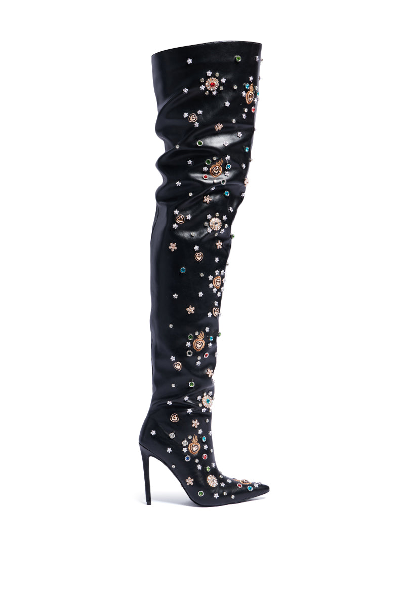 The AZALEA WANG BOBEE Black Embellished Boot, a single black thigh-high stiletto, crafted from sleek faux leather and adorned with intricate multicolored floral embroidery and embellishments, is showcased against a plain white background. 2