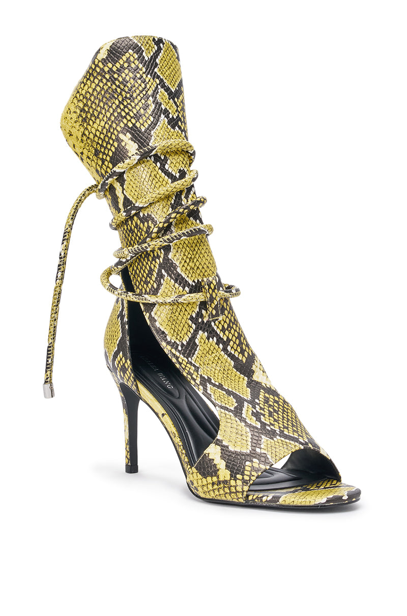 The AZALEA WANG BOCKER Yellow Snake Stiletto Lace Up Tall Shaft Sandal features a high heel, open toe, faux leather, and lace-up design with a yellow and black snakeskin pattern—ideal for a night out. 4