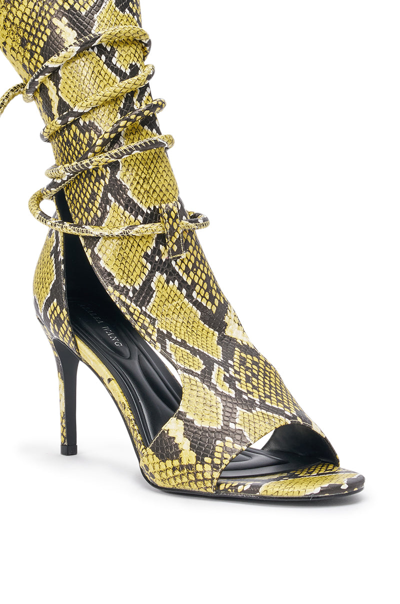 Make a bold statement on your night out with the AZALEA WANG BOCKER YELLOW SNAKE STILETTO LACE UP TALL SHAFT SANDAL, featuring yellow snakeskin-patterned faux leather, open toe, lace-up design, and a sleek stiletto heel. 6