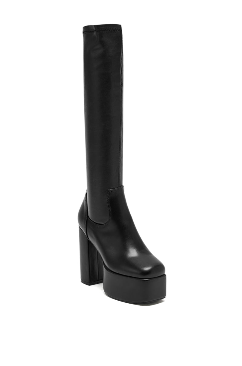 The AZALEA WANG BOMBON BLACK STRETCH PU CHUNKY BOOT features faux leather and a high heel, making it perfect for bold, stylish looks. 3