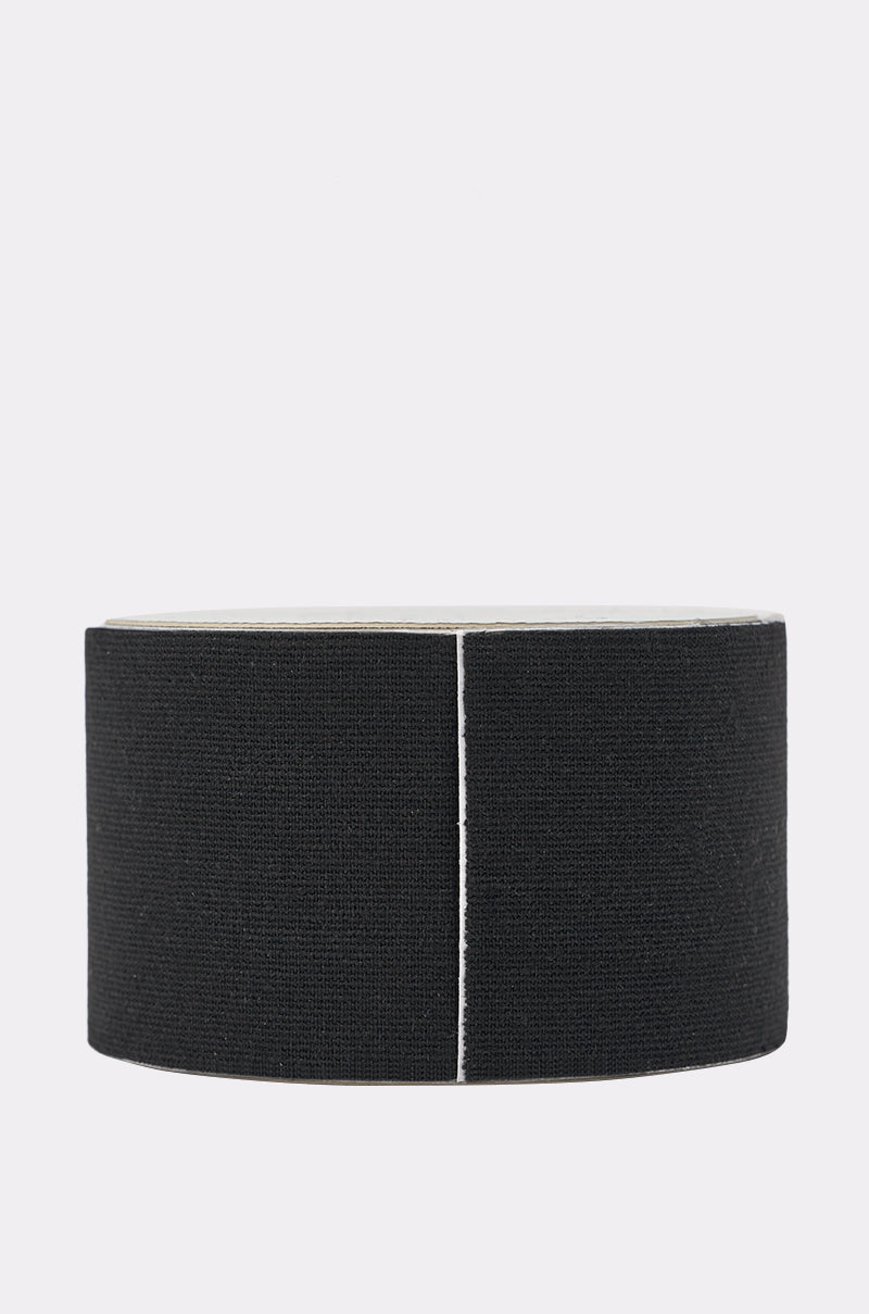 A roll of TITSY ULTRA LIFT BOOB TAPE IN BLACK, featuring a vertical split down the center, sits on a plain white background—ideal for discreet, no-show support. 1