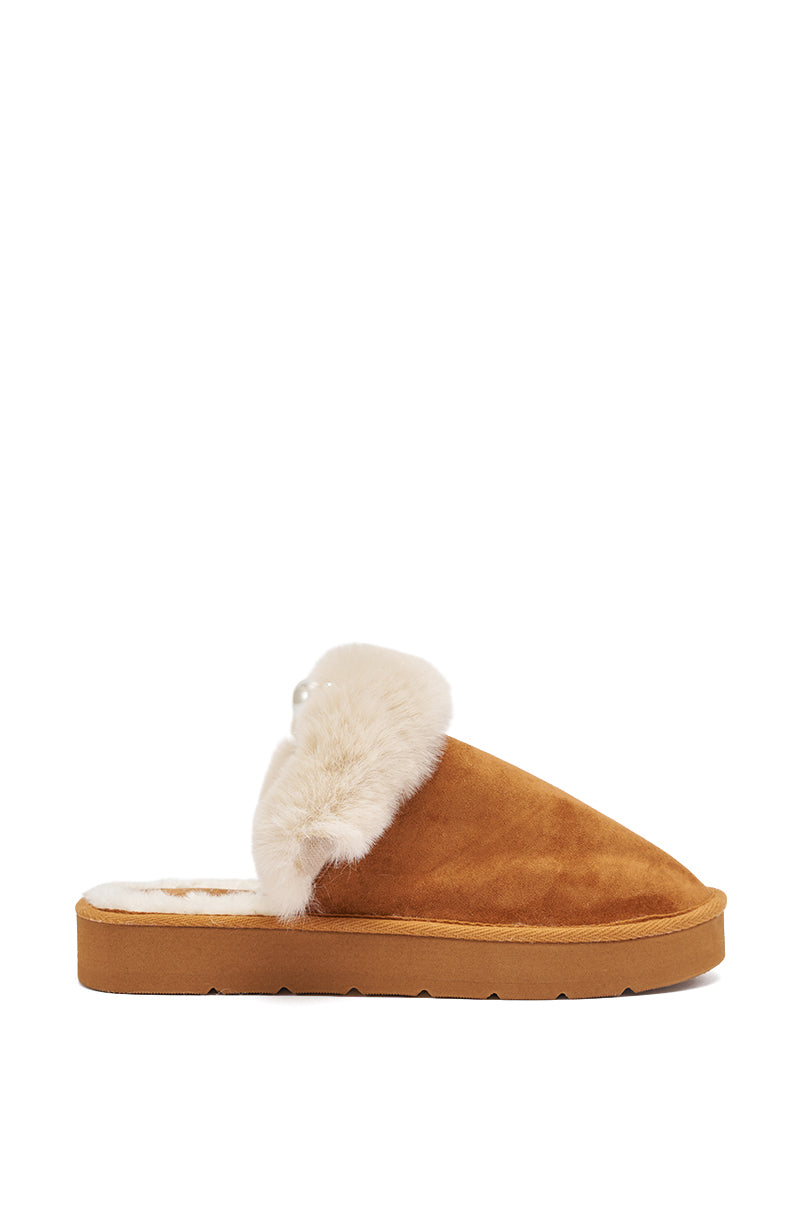 The AKIRA BOONE CAMEL SLIPPER WITH PEARLS features faux suede in camel, a fuzzy cream-colored lining and trim, pearl embellishments, and is shown in profile on a white background. 4
