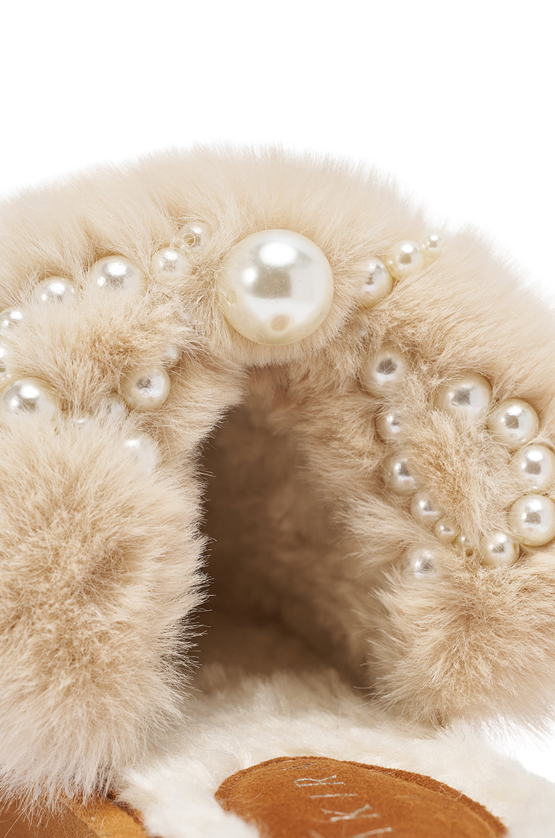 The AKIRA BOONE Camel Slipper with Pearls features soft beige faux suede and white faux pearls in assorted sizes, offering a luxurious and elegant look. 7