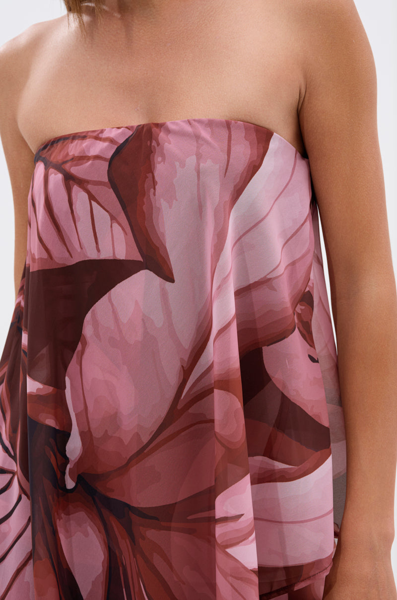 Someone wears the ON A BEACH SOMEWHERE Printed Jumpsuit in vibrant orange, featuring a strapless design and bold tropical floral print—smoothly draped and stylish, perfect for summer parties or beach getaways. 4