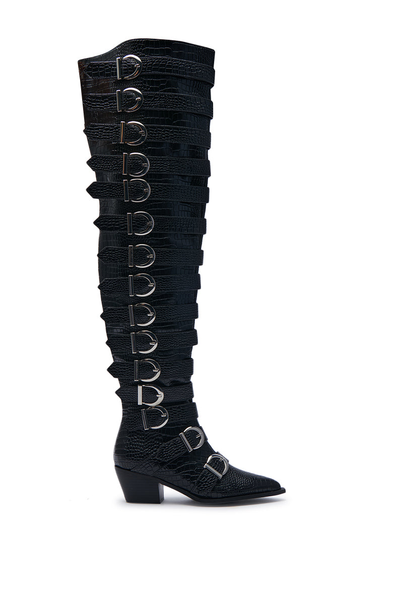 Introducing the AZALEA WANG BRAULIA BLACK CROC WESTERN BOOT: a standout knee-high boot crafted from faux crocodile leather, highlighted by multiple horizontal straps and prominent silver buckles adorning the side. This boot features a textured reptile-like design and a chunky heel, offering both style and boldness.