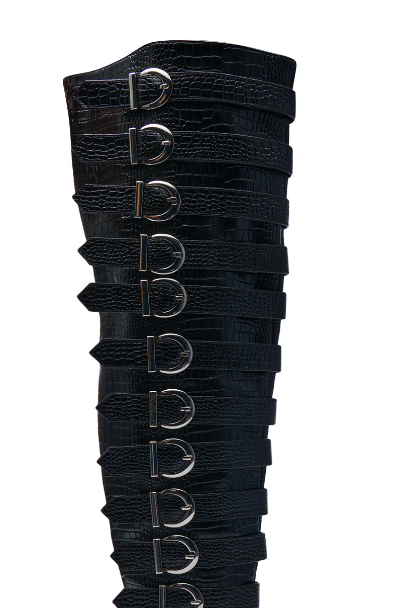 A close-up of the AZALEA WANG BRAULIA BLACK CROC WESTERN BOOT showcases its croc texture with multiple straps and silver buckles along the side.