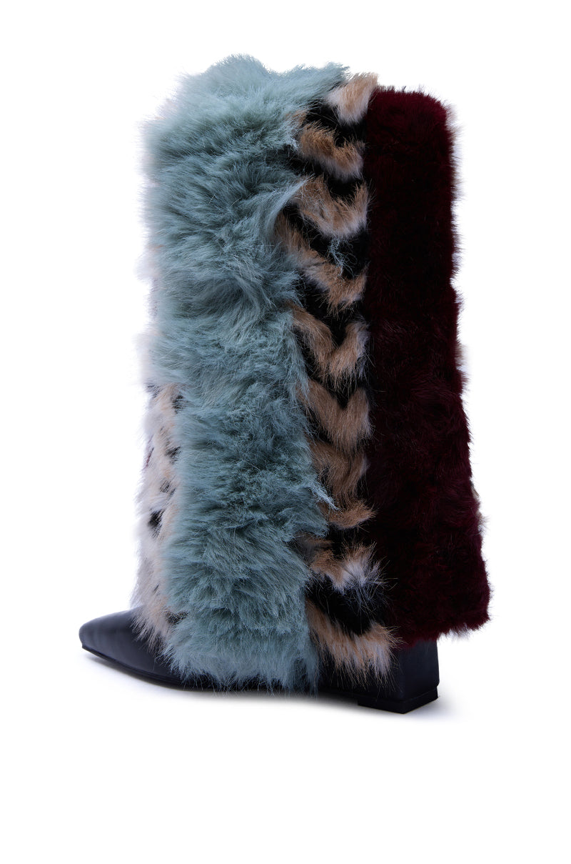 The AZALEA WANG BRIASH BLUE MULTI FUR HIDDEN WEDGE BOOTIE is a mid-calf, pointed-toe boot covered in fluffy faux fur strips of light blue, brown, black, and deep burgundy for a bold and textured look.