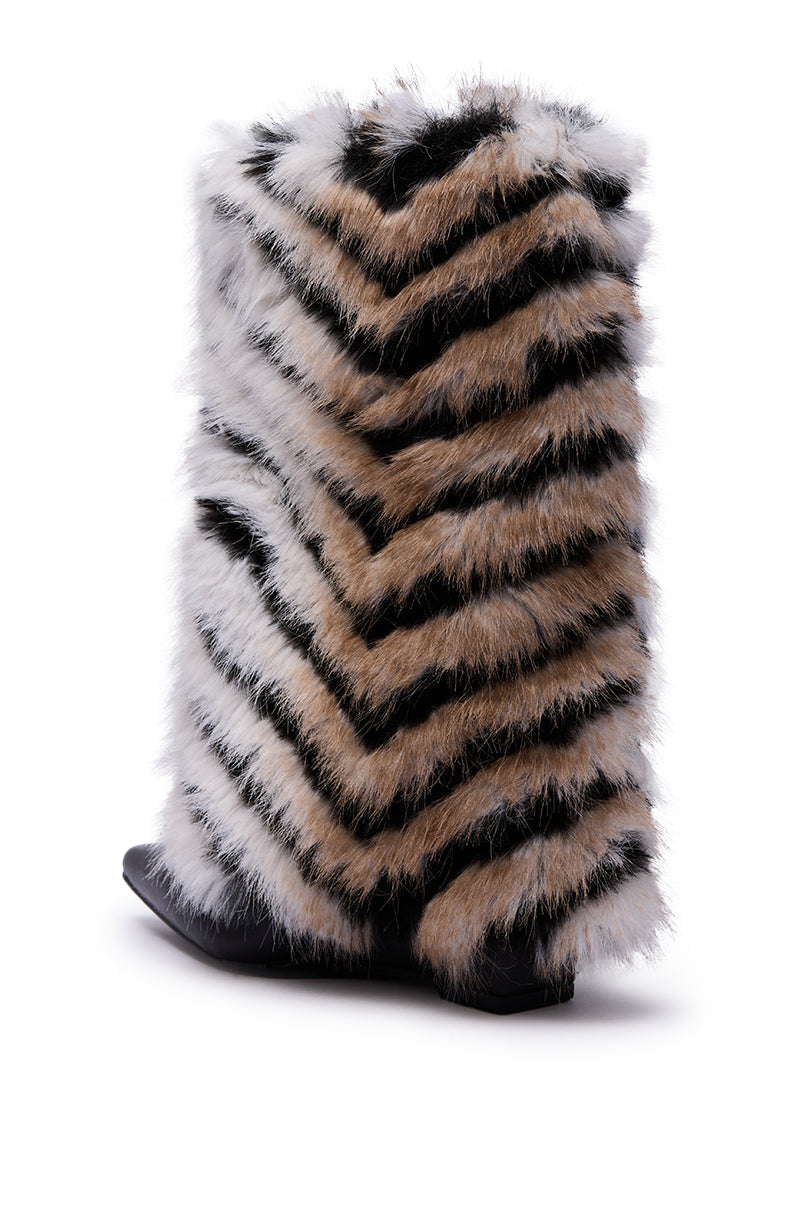 The AZALEA WANG BRIENNE BLACK FUR HIDDEN WEDGE BOOTIE is a single knee-high faux leather shoe with black, white, and brown zigzag faux fur, a pointed toe, and black sole, angled on a white background.
