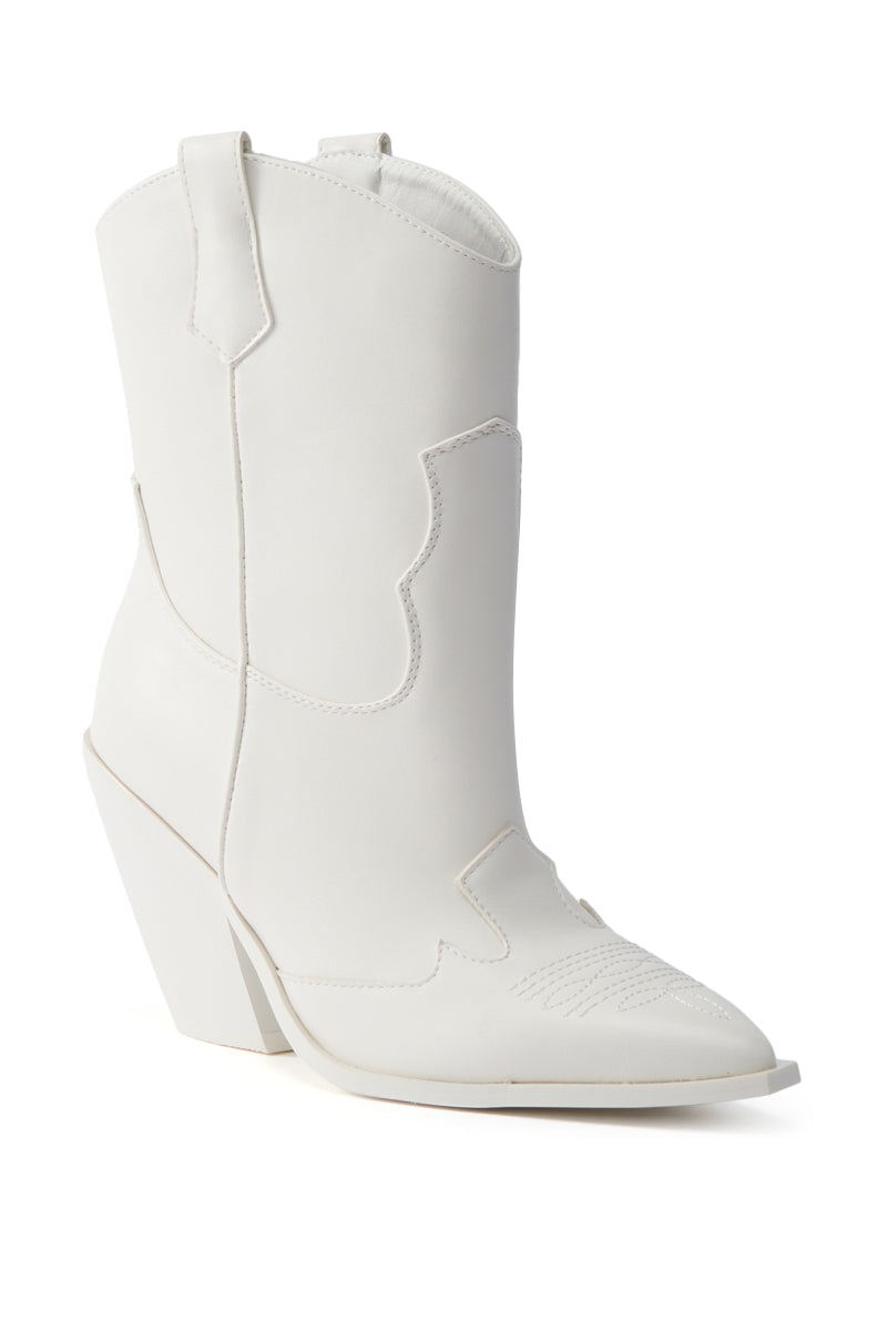 The AZALEA WANG BRIGGITTA WHITE WESTERN COWBOY BOOTIE is a white, mid-calf faux leather bootie with a pointed toe, decorative stitching, and a slanted block heel, shown against a plain white background.