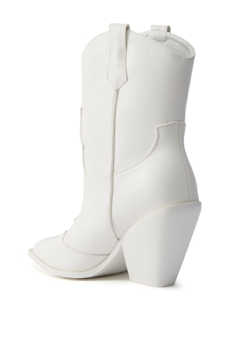 The AZALEA WANG BRIGGITTA WHITE WESTERN COWBOY BOOTIE features a white faux leather finish, pointed toe, pull tabs, and a chunky angled high heel. Shown from the back and side on a plain white background for cowgirl chic style.