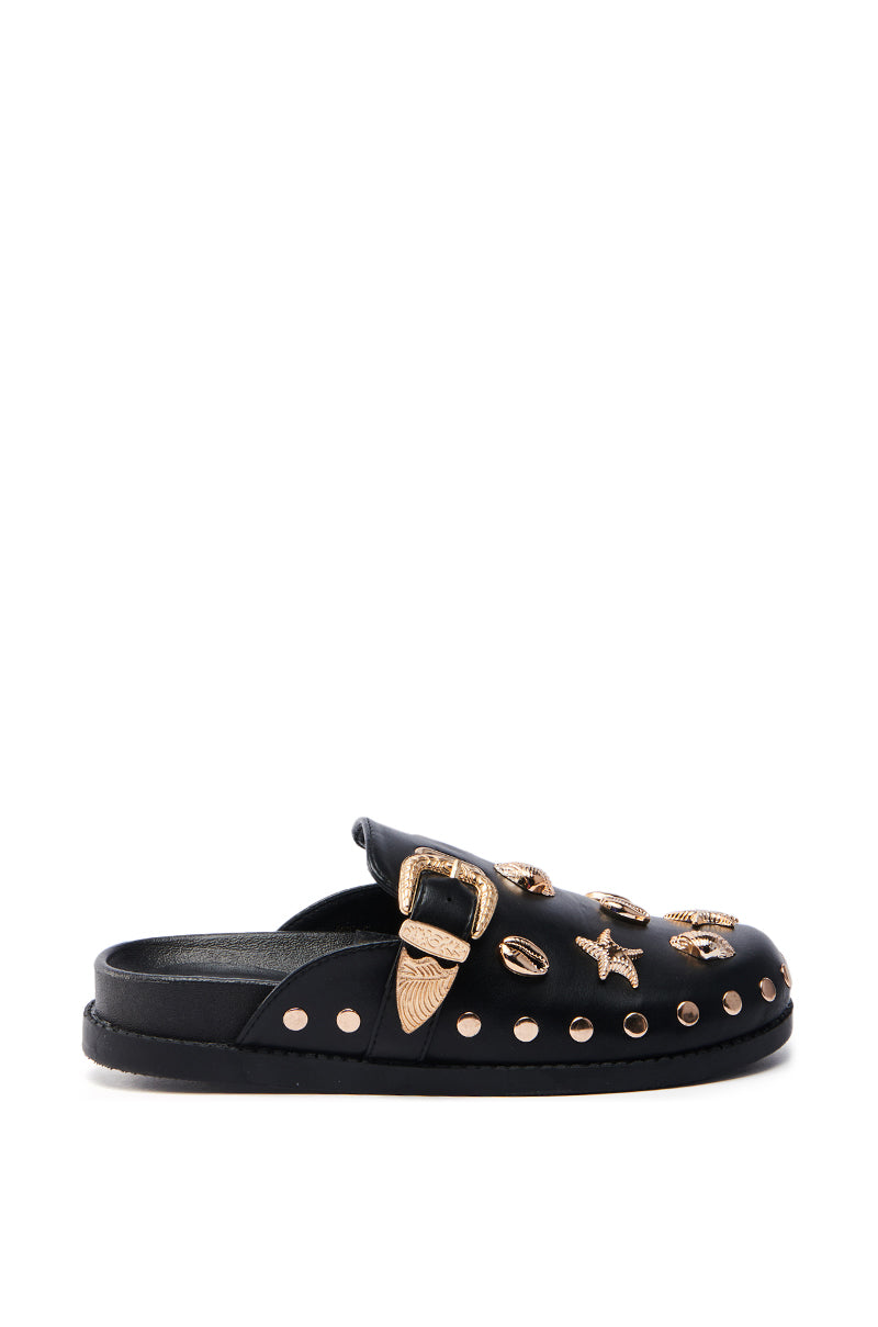 The AZALEA WANG BRINY BLACK SEA SHELL EMBELLISHED CLOG is a black slip-on crafted from vegan leather with an almond toe and low heel, featuring gold-toned embellishments like a buckle, seashells, starfish, and small gold studs along the sole.