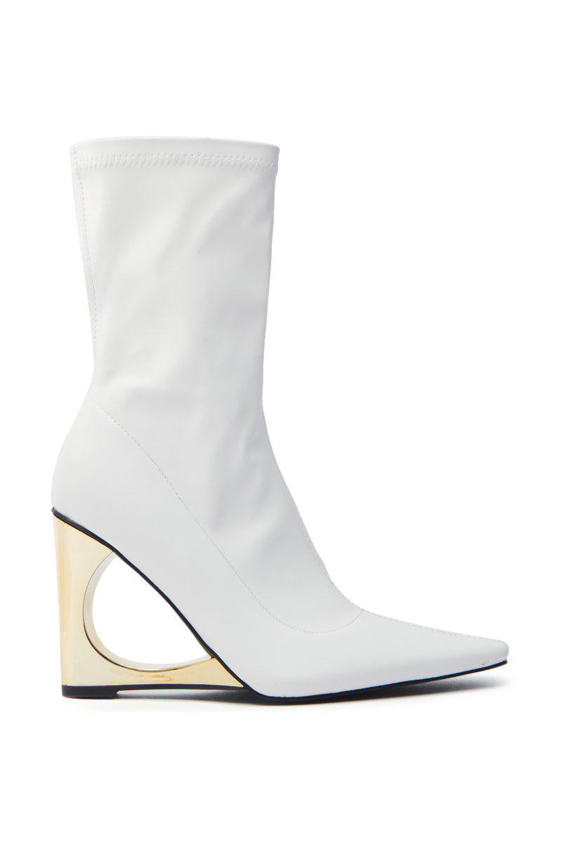 The AZALEA WANG BRIXHAM white bootie features ankle-length vegan leather, a pointed toe, and a gold geometric wedge heel with an open circular design for smooth texture and minimalist elegance.