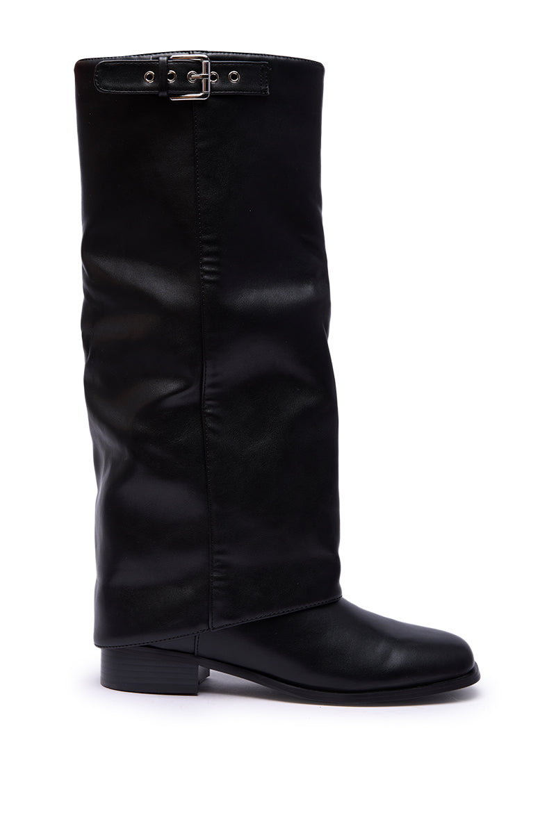 The AZALEA WANG BRONTE BLACK FLAT KNEE HIGH RIDING BOOT features a tall black design with a low heel, loose shaft, and decorative buckle strap near the top, shown against a plain white background.
