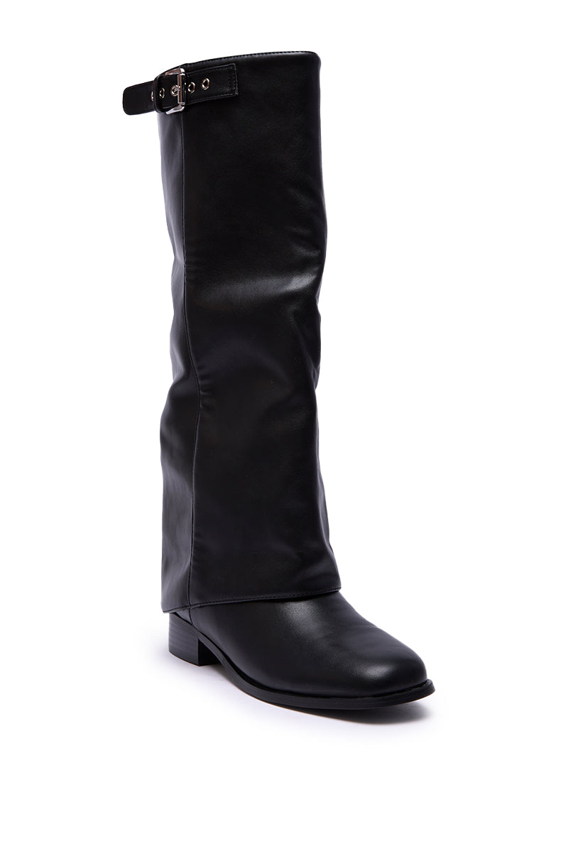 The AZALEA WANG BRONTE BLACK FLAT KNEE HIGH RIDING BOOT features a tall black faux leather design with a slightly slouched shaft, low heel, and a decorative buckle strap near the top for classic knee-high style.