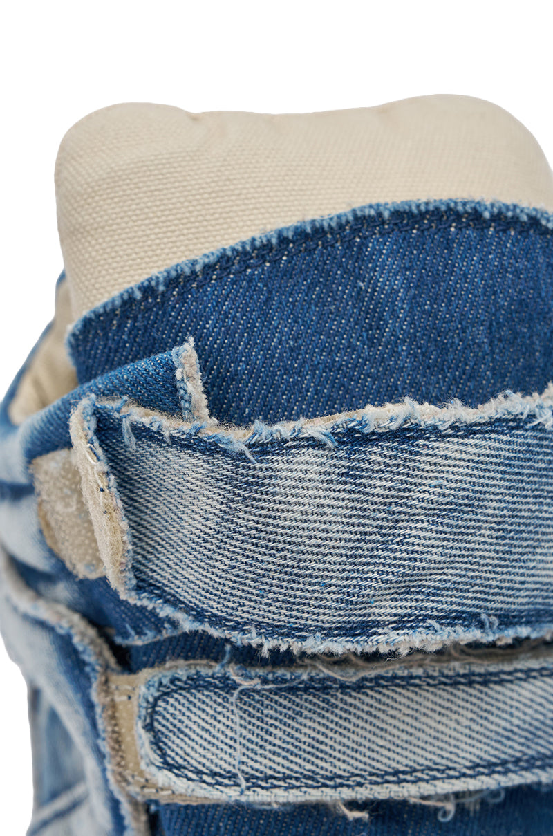 Close-up of the AZALEA WANG BRYANT DENIM WEDGE SNEAKER shows frayed denim edges, a beige padded tongue, and detailed stitching—highlighting its bold texture for standout streetwear style. 6