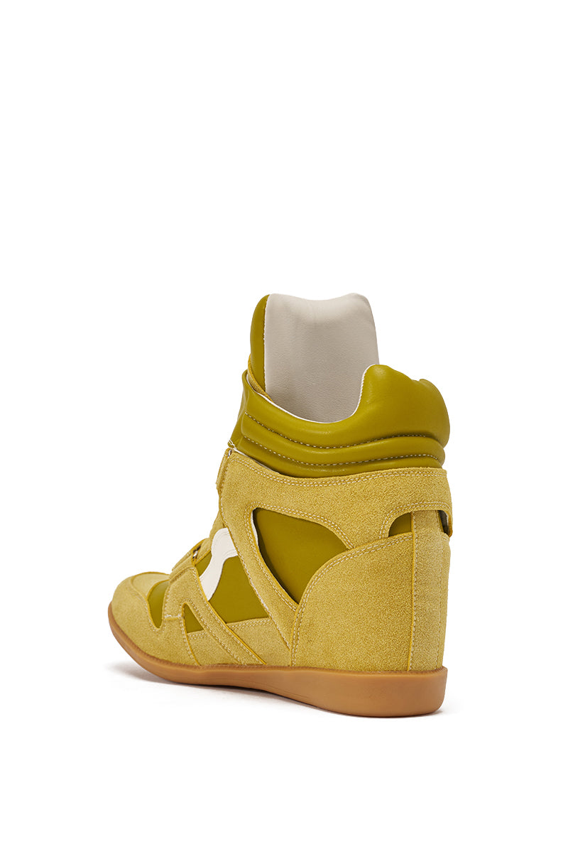 The AZALEA WANG BRYANT OLIVE WEDGE SNEAKER features suede and faux leather panels, white lining, a tan gum sole, and cutout accents. Displayed from a rear side angle on a white background. 5