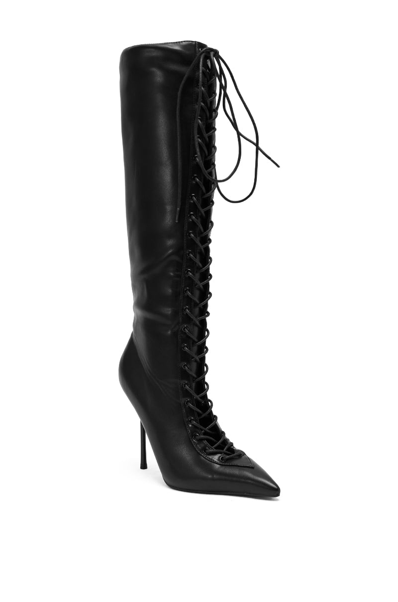 The AZALEA WANG BUCHANAN LACE UP BOOT IN BLACK is a tall, black leather knee-high boot with a pointed toe, stiletto heel, and chic front lace-up design, displayed against a white background. 6