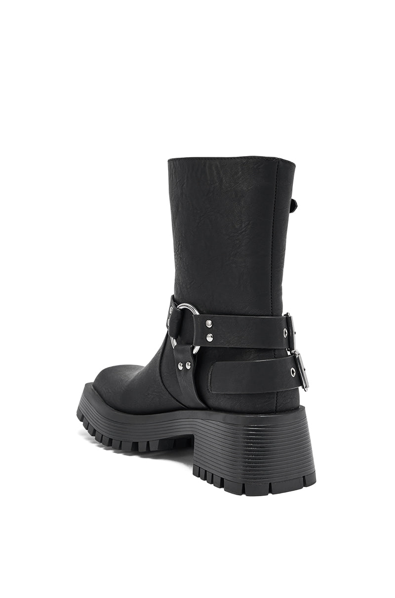 The AZALEA WANG BUCKED BLACK CHUNKY HEEL COMBAT BOOTIE is a black faux leather mid-calf boot with a chunky heel, thick treaded sole, silver buckles, and ankle straps for a stylish, rugged look—shown from the back.