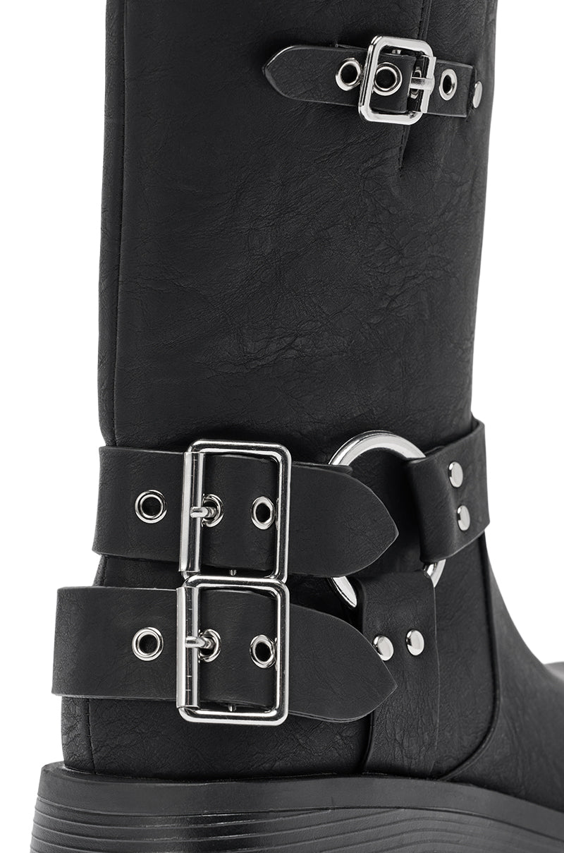 The AZALEA WANG BUCKED BLACK CHUNKY HEEL COMBAT BOOTIE features three silver buckles, decorative straps on the ankle and shaft, textured faux leather, and visible stitching.