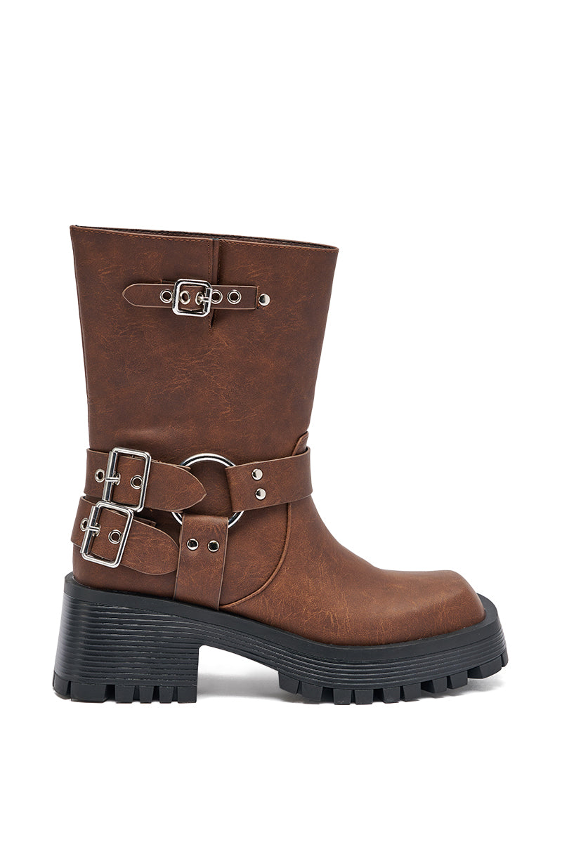 The AZALEA WANG BUCKED BROWN CHUNKY HEEL COMBAT BOOTIE is a mid-calf faux leather boot with a chunky black sole, silver buckles, and decorative straps for a bold and stylish look. 5